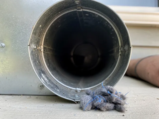 Guilford Dryer Vent Cleaning technician using specialized equipment to clear severe dryer vent blockage in Guilford